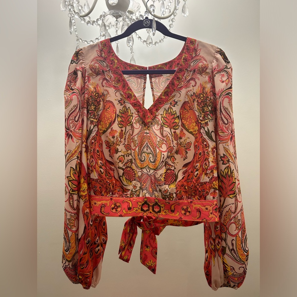 Size XL A. Peach peacock print top